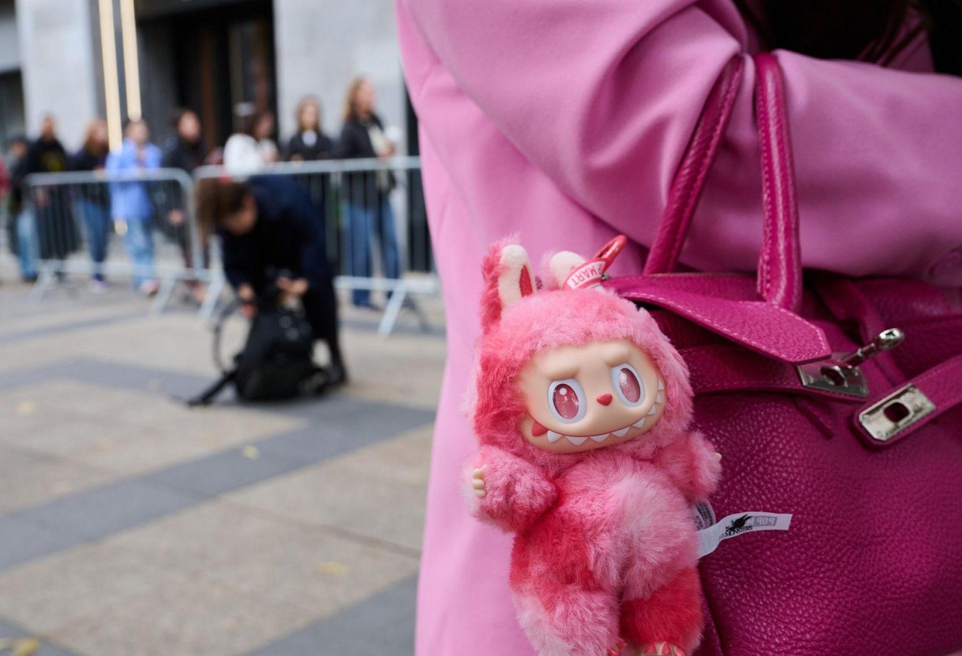 Fans brachten ihre eigenen Labubus mit. (Bild: Annette Riedl/dpa)