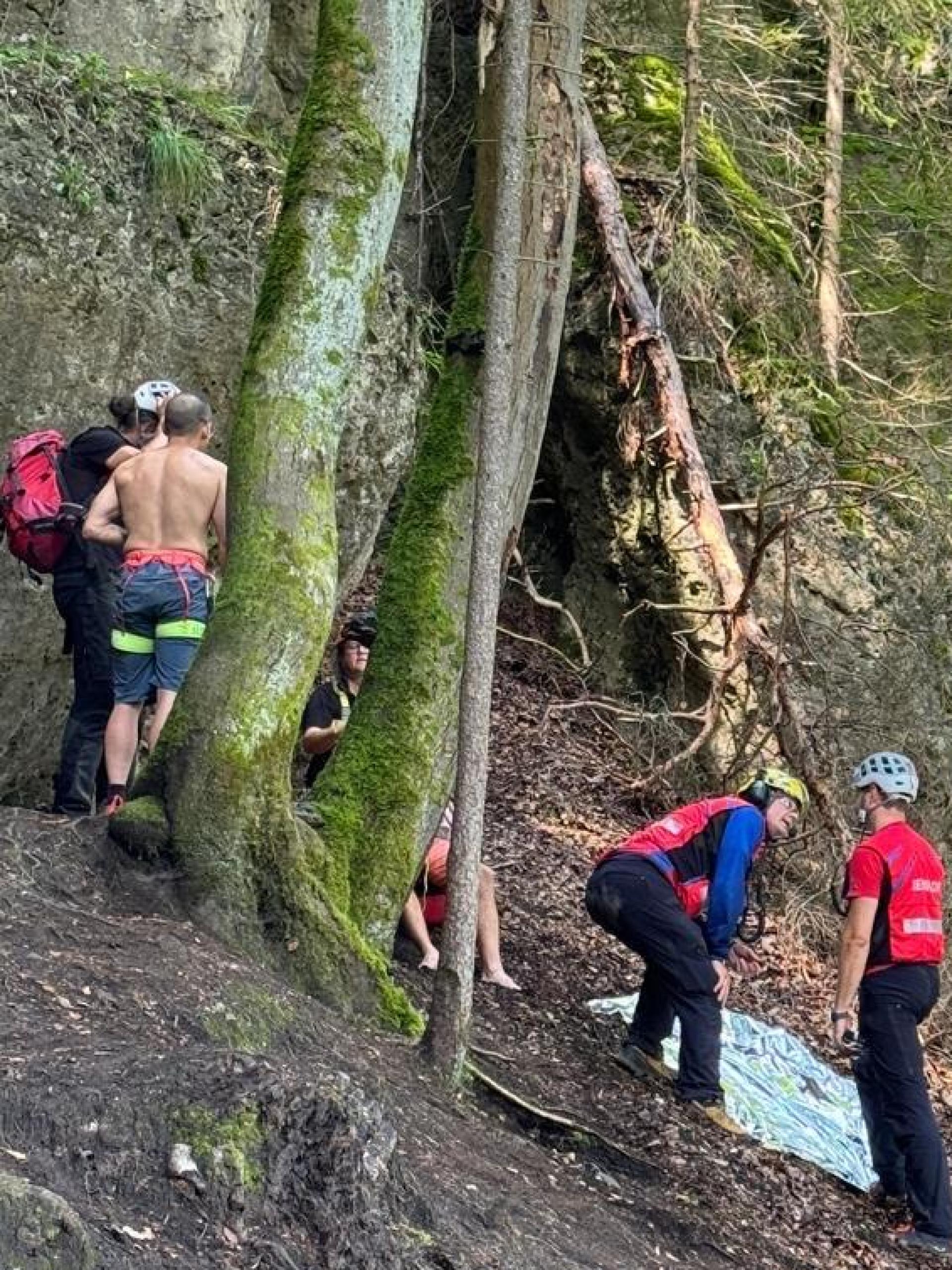 Helfer bereiten die Bergung eines gestürzten Kletterers aus steilem Gelände vor. (Bild: Roland Melk/exb)
